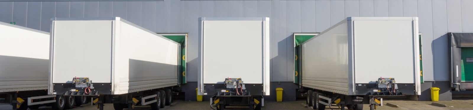 Tailers at docking stations of a distribution centre waiting to be loaded